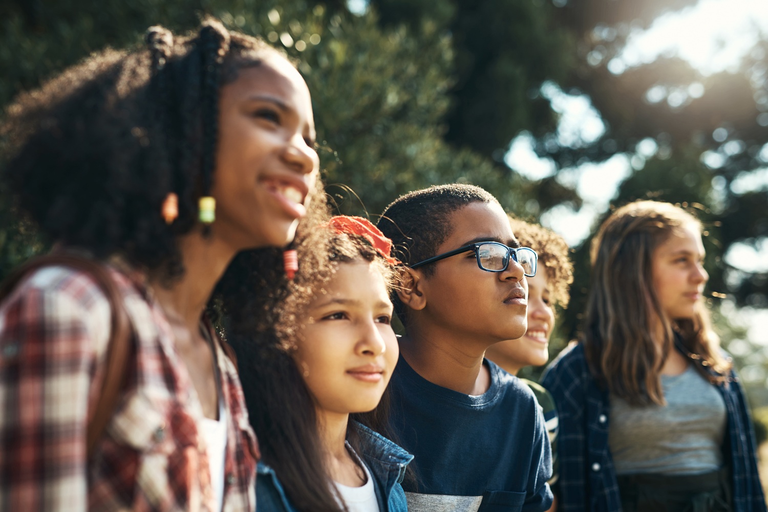 Shot of a group of teenagers having fun in nature at summer camp.