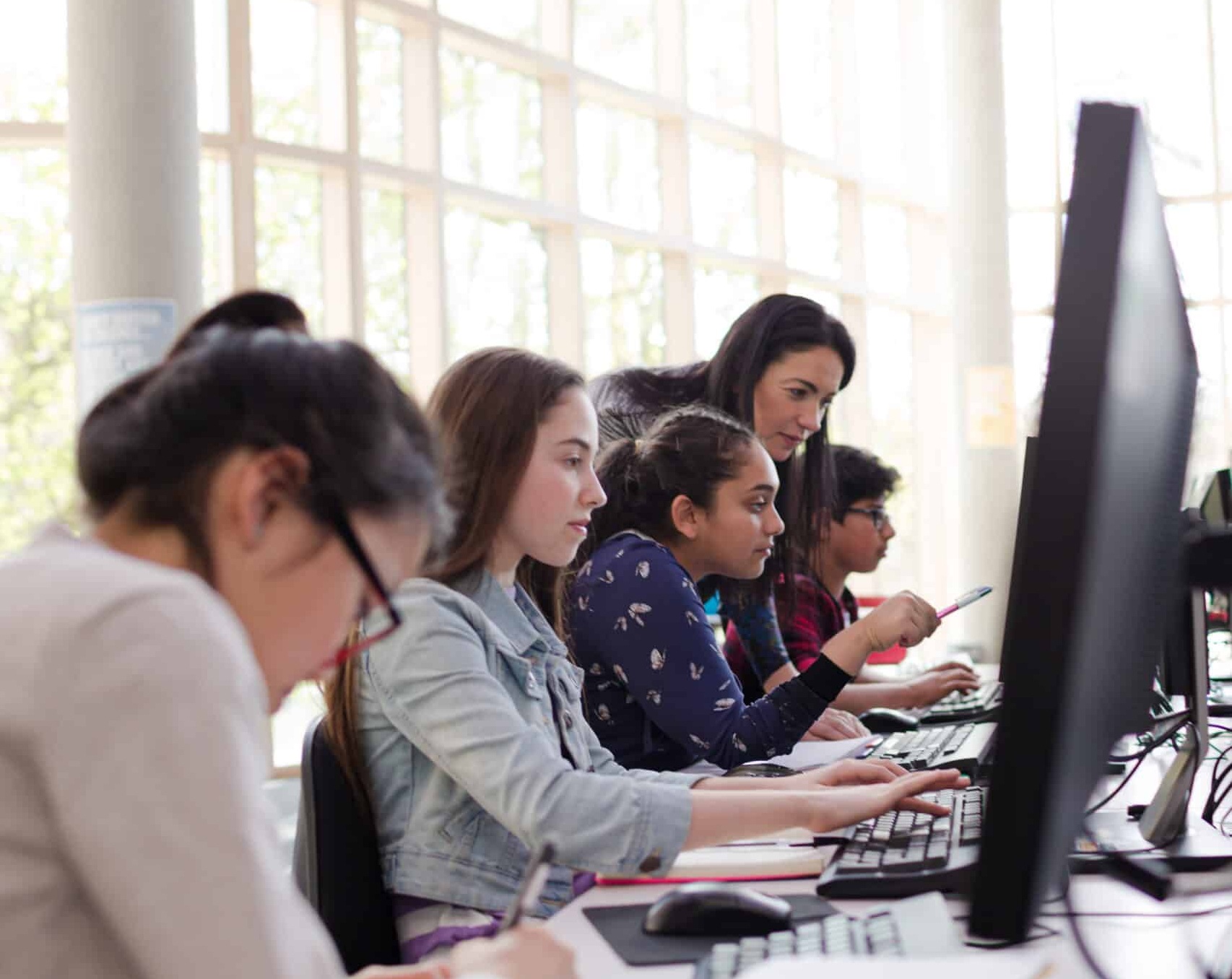 Students using computer in library